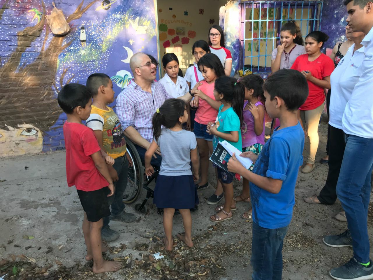 Niños y hombre adulto en silla de ruedas