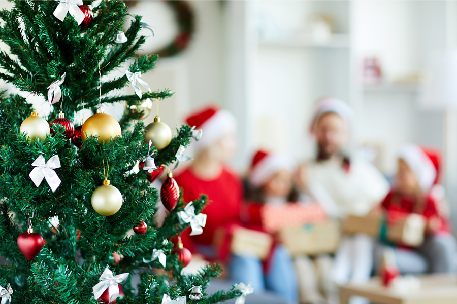 arbol de navidad con familia de fondo