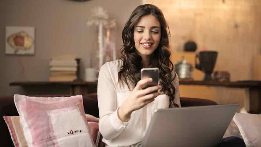 Joven con smartphone en mano sonriendo