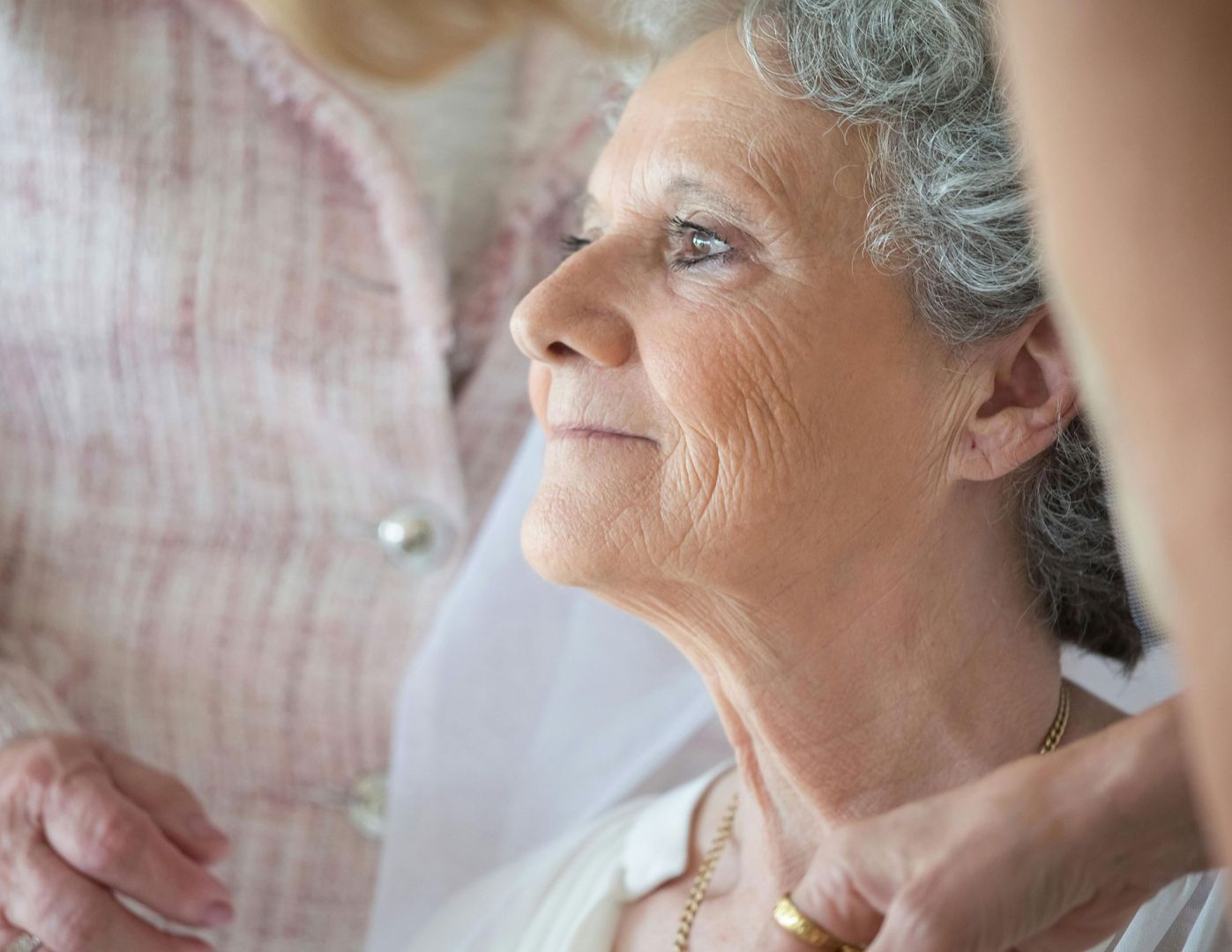 Mujer de la tercera edad es atendida por otras mujeres.