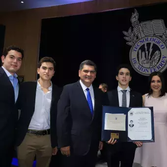 alumnos posando con el título